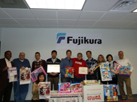 Employees with Jessica, who visited FAA as a representative of Toys for Tots (fifth person from right in the back row)